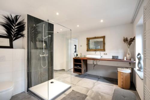 a bathroom with a glass shower and a sink at Klosterperle in Neuruppin