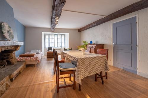 a dining room with a table and chairs and a fireplace at Sarzeau centre - Le Cormoran in Sarzeau