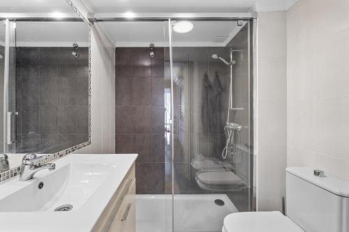 a bathroom with a shower and a sink and a toilet at Casa Deti in Roses