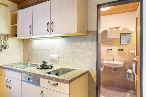 a small bathroom with a sink and a toilet at Ferienwohnung Reintal in Grainau