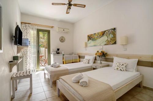 a bedroom with two beds and a living room at Nontas Home 20 in Kalamitsi