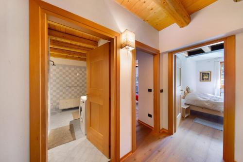 a hallway with a bedroom and a bed in a room at Villa Cleila Blu D in San Vito di Cadore