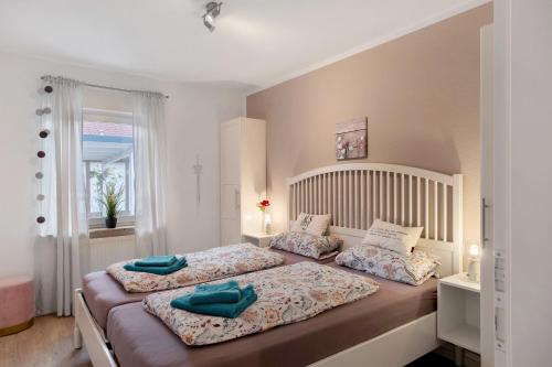 a bedroom with two beds and a window at Ferienhaus Apfelzauber in Twielenfleth
