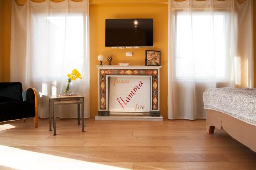 a bedroom with a fireplace with a tv on the wall at Rarity Suites in Rome