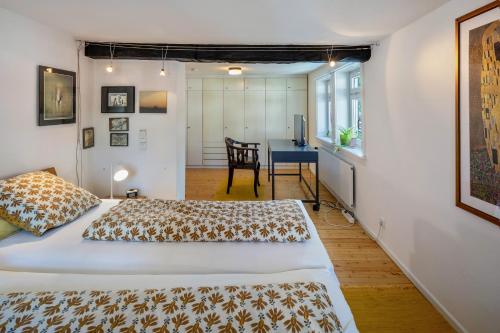 a bedroom with two beds and a desk at Ferienhaus Schotten in Schotten