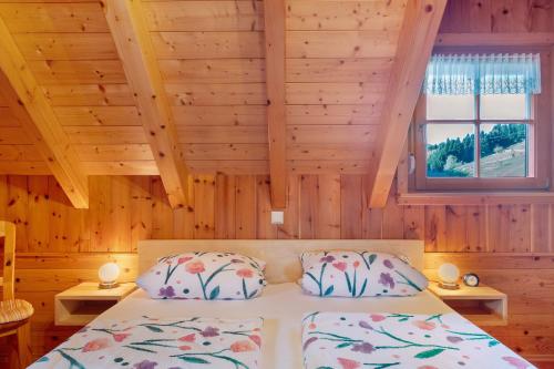 a bedroom with a bed in a wooden room at Geigerseppleshof in Mühlenbach