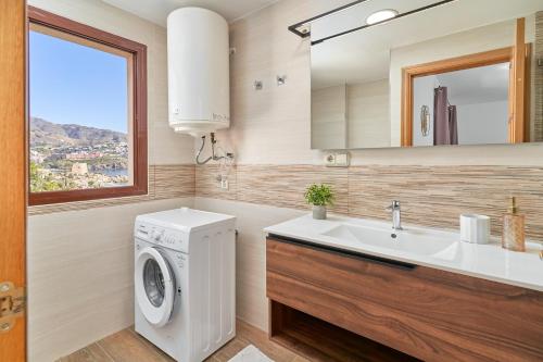 a bathroom with a washing machine and a sink at Argali Beach Almuñecar in Almuñécar