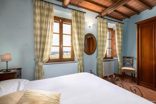a bedroom with a bed and a window at Podere San Bartolo- Casa colonica 3 in Barberino di Val dʼElsa