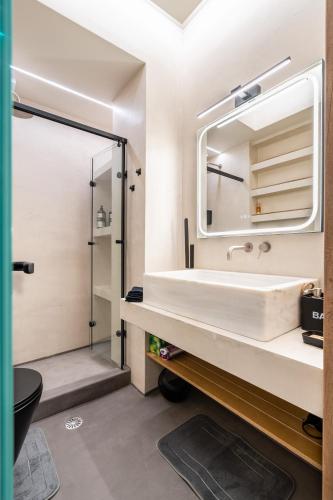 a bathroom with a sink and a mirror at The Apex Boutique Apartment B1 in Athens