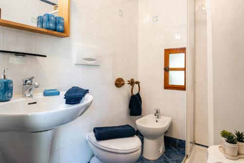a bathroom with a toilet and a sink at Il Colletto Romantic Stonehouse in Pescia