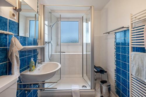 a bathroom with a sink and a shower at Haus Loks in Sankt Märgen