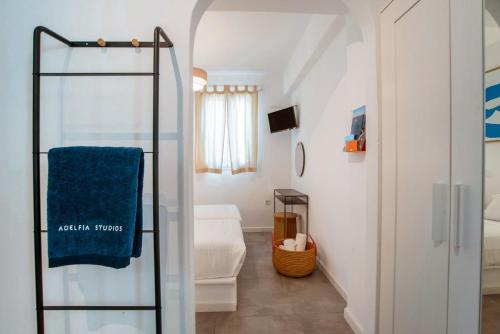 a bathroom with a shower and a blue towel at Adelfia Studios in Parikia