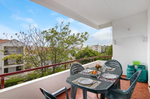 a table and chairs on a balcony with a view at Beach House-5 Minutos a pé da praia in Manta Rota