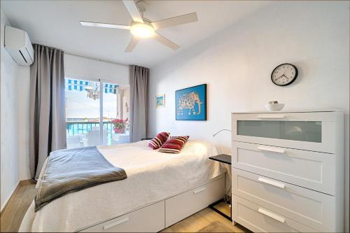 a bedroom with a bed and a clock on the wall at Casa Altea-mar in Altea