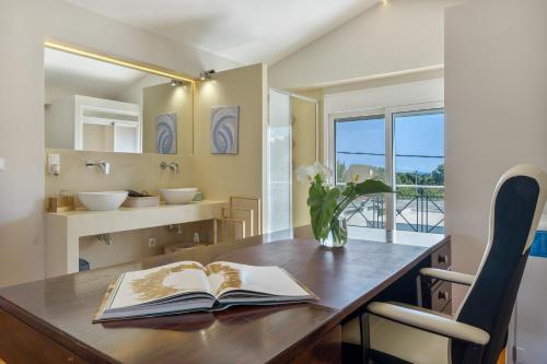 a room with a wooden table with two books on it at Artemida Beach House in Artemida