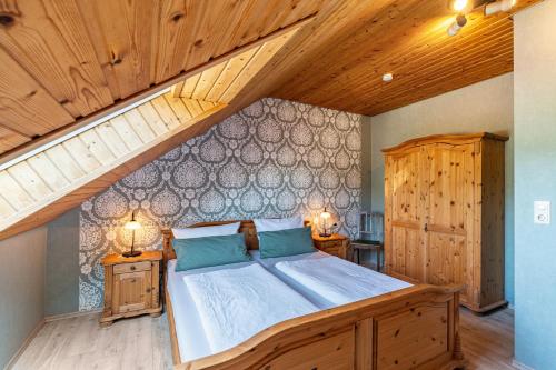 a bedroom with a large bed and an attic at Haus Berger in Seebach