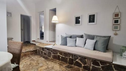 a couch in a living room with pillows on it at Mediterranean Villa Megara in Megara