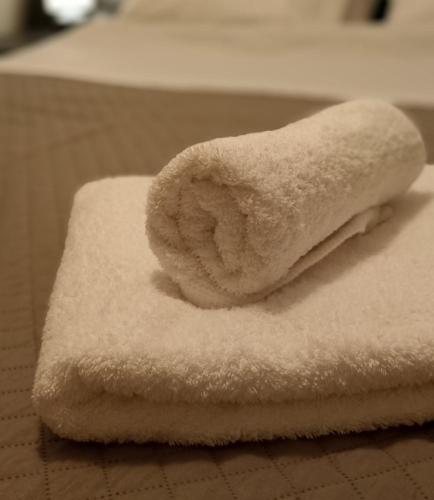 a pile of white towels sitting on a table at The Beach House in Porto Rafti