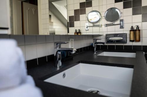 a bathroom with a sink and a mirror at Hotel Azenberg in Stuttgart