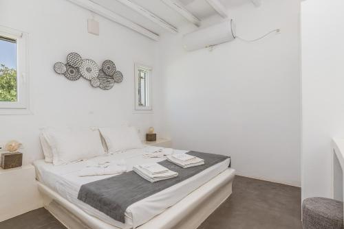 a white bedroom with a large bed in a room at Ow Andros Suite 3,Private Whirlpool in Andros
