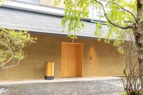 a brown building with a brown door on it at Fufu Kyoto in Kyoto