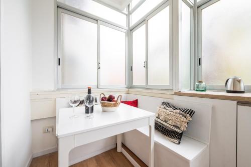 a white table in a kitchen with windows at Sa Babbajola in Cagliari