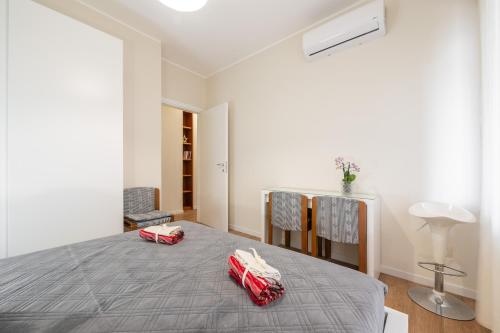 a bedroom with a bed with red pillows on it at Sa Babbajola in Cagliari