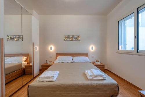 a bedroom with a large bed and a window at San Giorgio Rooms in Cavallino di Lecce