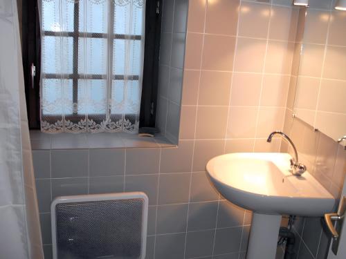 a bathroom with a sink and a window at Le Paillassou in Blanzac
