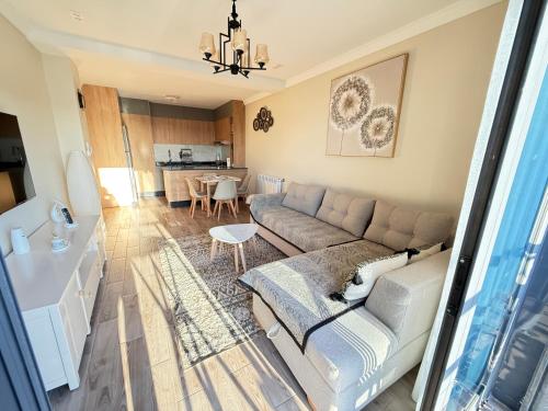 a living room with a couch and a table at Panoramic View apartment Seraidi Annaba in Annaba