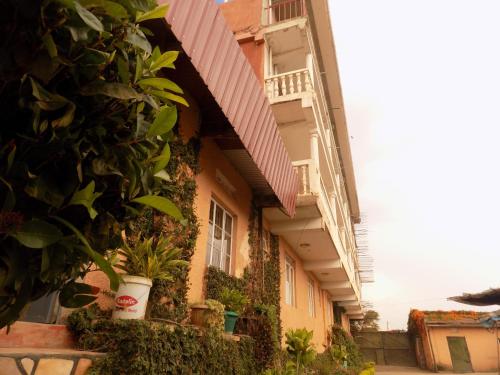 a building with plants on the side of it at Meliva Guest House Mbarara in Mbarara
