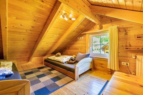 a room with a bed in a log cabin at Haus Miriam in Walchum