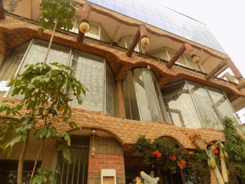 a brick house with large windows on it at Meliva Guest House Mbarara in Mbarara