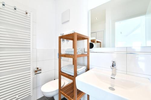 a bathroom with a toilet and a sink at Dinkelbach Feriendomicil 2 C in Lindau-Bodolz