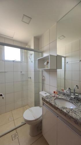 a bathroom with a toilet and a sink and a shower at Flat 707 Moderno e Espaçoso, próximo ao Praia Clube in Uberlândia