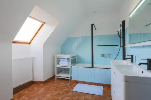 a bathroom with a sink and a glass shower at Les Camelias in Locquirec
