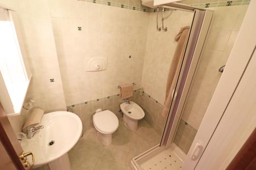 a bathroom with a toilet and a sink and a shower at Casa Vacanze Martina a Otranto in Otranto