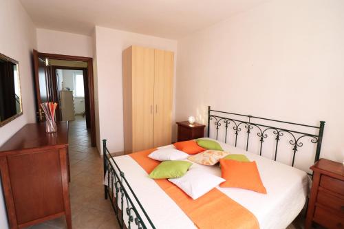 a bedroom with a bed with pillows on it at Casa Vacanze Martina a Otranto in Otranto