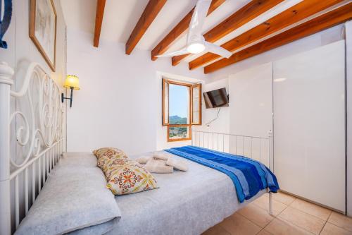 a bedroom with a bed and a tv on a wall at Eliasneil in Andratx