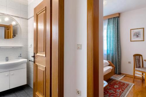 a bathroom with a sink and a toilet and a mirror at Mayr Apartments Drei in Plaus