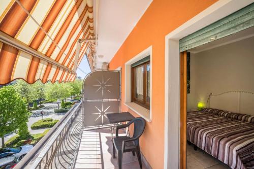 a balcony with a bed and a table and chairs at Appartamento Croce del Sud 8 in Bibione