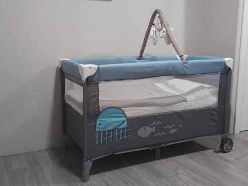 a blue crib bed in a room at Apartamento ms in Campo Maior