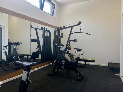 a gym with several tread machines in a room at Elia Residence Rooms in Bečići