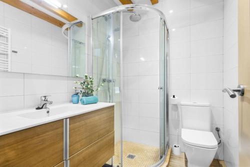a bathroom with a shower and a sink and a toilet at Can Darder in Sóller