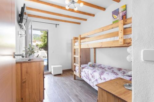 a bedroom with a bunk bed and a desk at Can Darder in Sóller