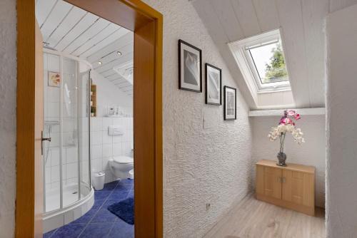 a bathroom with a toilet and a window at Sara´s Ferienwohnung in Plettenberg