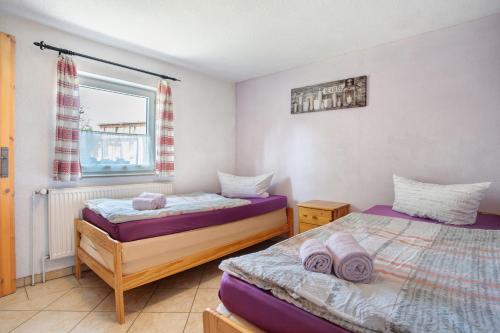 a bedroom with two beds and a window at Ferienhaus Struve in Trent