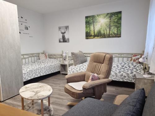 a living room with a couch and a chair at Ferienwohnung Kuckuck in Ohlsbach
