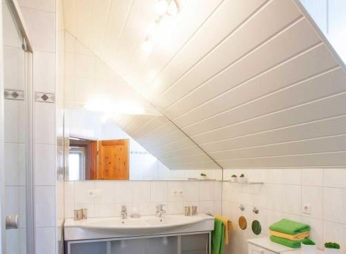 a bathroom with a sink and a mirror at Ferienwohnungen Merkle in Wasserburg