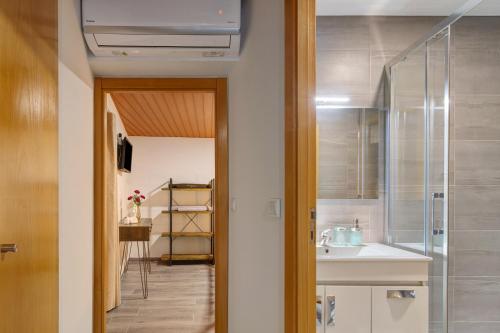 a bathroom with a sink and a shower at Casa Da Capela in Entre Ambos os Rios